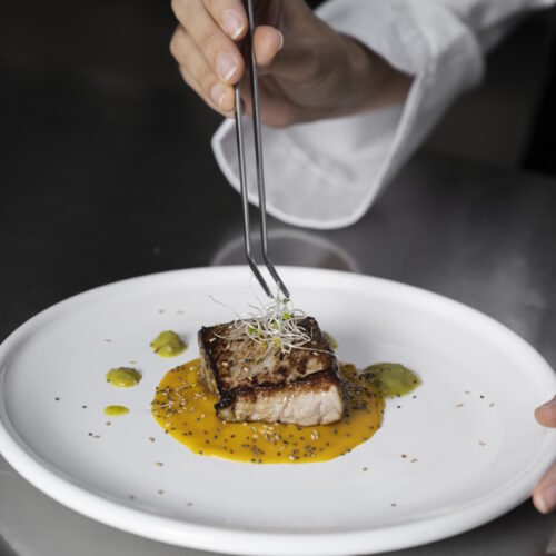 female-chef-kitchen-preparing-plate-steak female-chef-kitchen-preparing-plate-steak