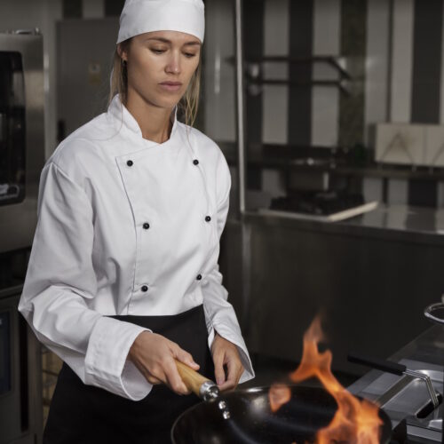 female-chef-kitchen-flambeing-food female-chef-kitchen-flambeing-food